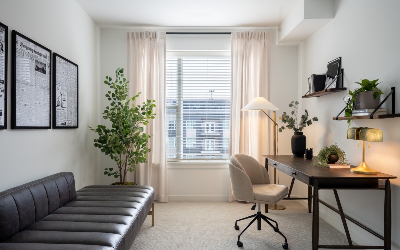 room with a desk and a couch 