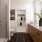 bathroom with dual sinks with a walk in shower and a walk in closet in the background