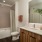 bathroom with backlit mirror and bath shower