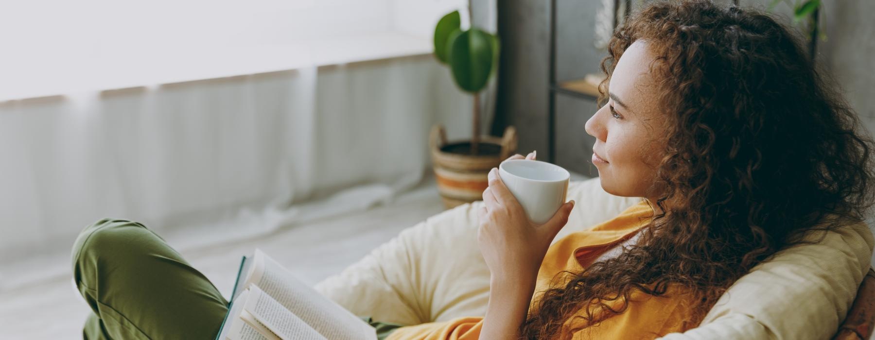 a person sitting on a couch reading a book