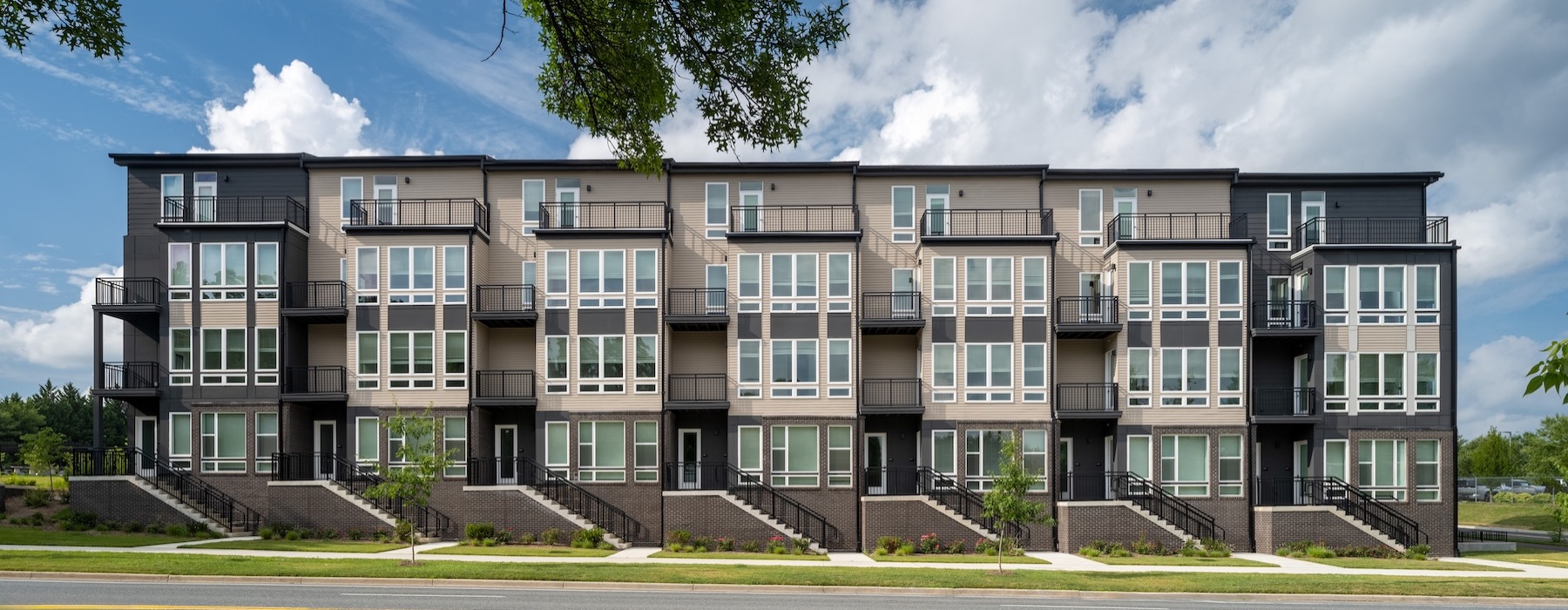 an apartment building with a lawn